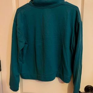 This is a dark green and light grey pullover from colsie